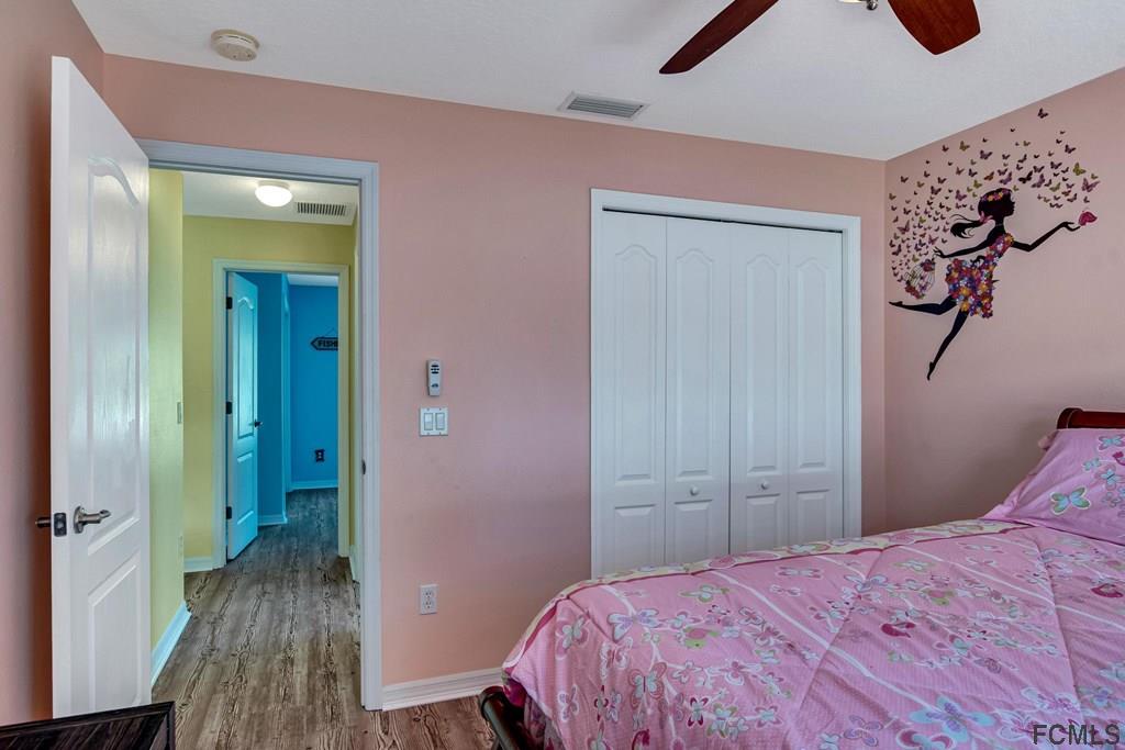 102 Ulysses Trail Palm Coast, FL 32164 - Photo 46 of 62 a bedroom with a bed and a mirror