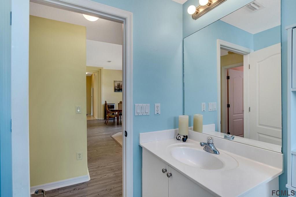 102 Ulysses Trail Palm Coast, FL 32164 - Photo 48 of 62 a en suite bathroom with a sink and mirror