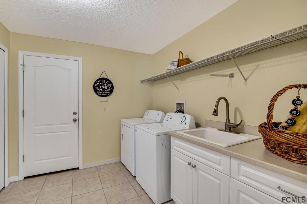 102 Ulysses Trail Palm Coast, FL 32164 - Photo 49 of 62 a utility room with dryer and washer