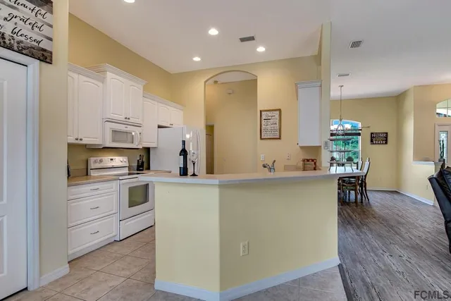 a kitchen with stainless steel appliances a sink stove and cabinets