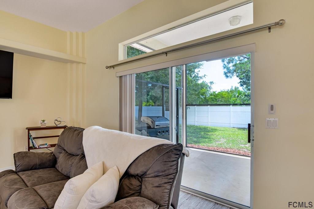 102 Ulysses Trail Palm Coast, FL 32164 - Photo 51 of 62 a living room with furniture and a window