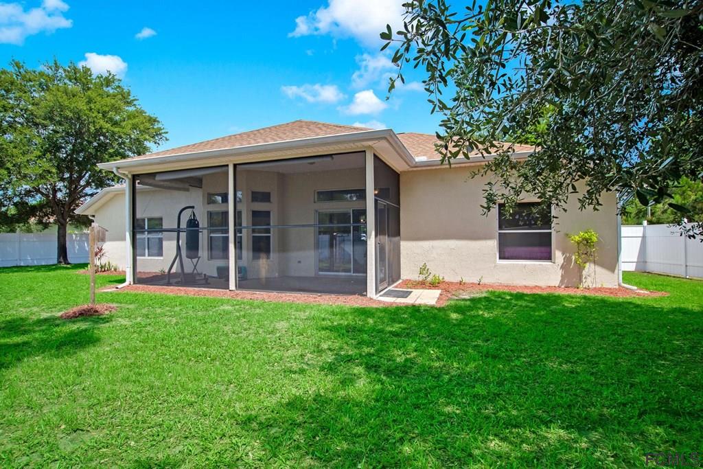 102 Ulysses Trail Palm Coast, FL 32164 - Photo 56 of 62 a view of a house with a yard and sitting area