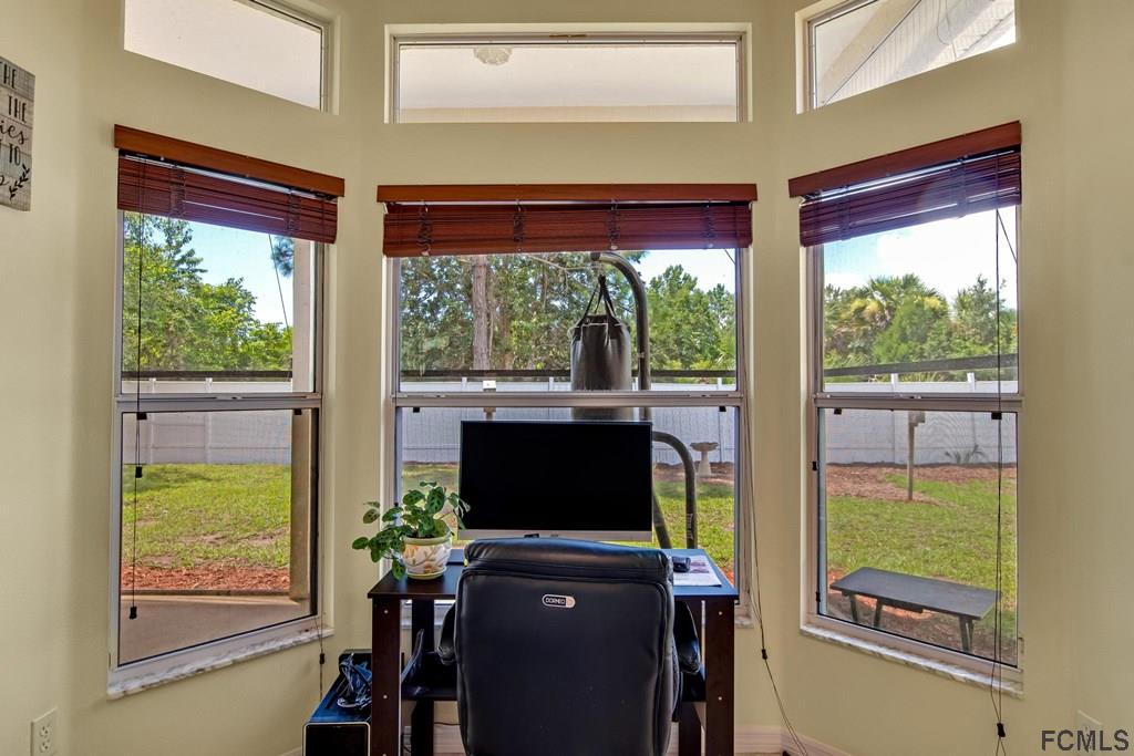 102 Ulysses Trail Palm Coast, FL 32164 - Photo 58 of 62 a living room with a large window and floor to ceiling window