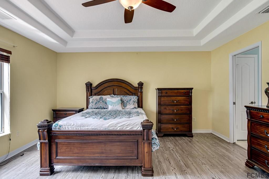 102 Ulysses Trail Palm Coast, FL 32164 - Photo 6 of 62 a bedroom with a bed and a dresser