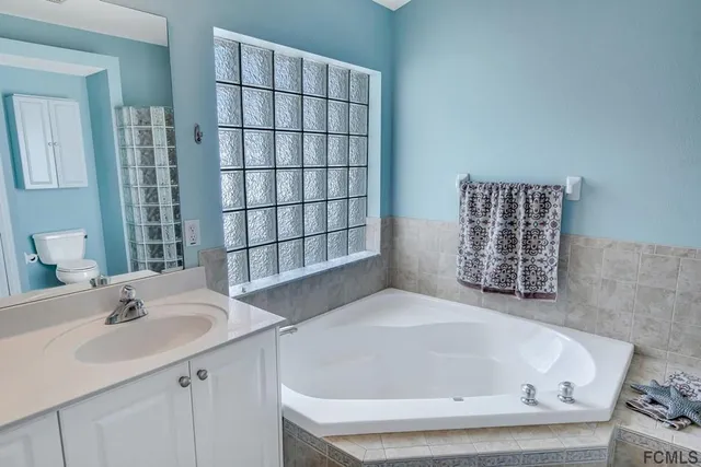 a bathroom with a bathtub and a sink