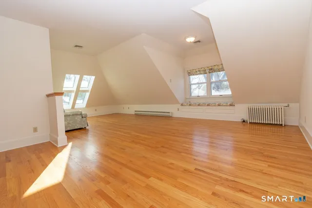 a view of a room with wooden floor