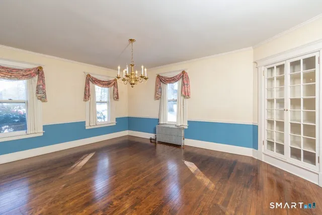 wooden floor in an empty room with a window
