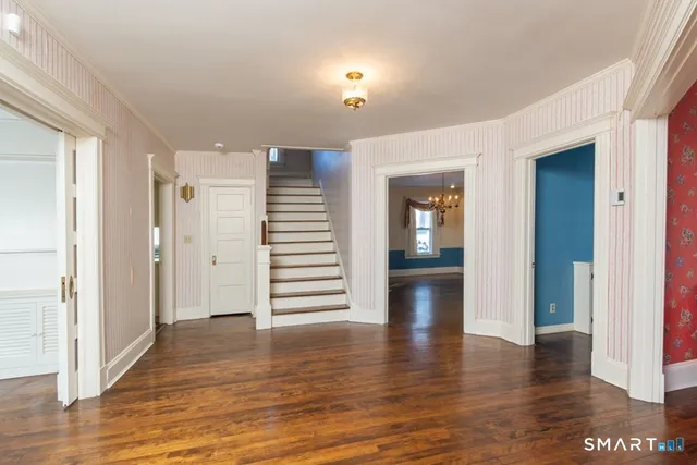 a view of empty room with wooden floor