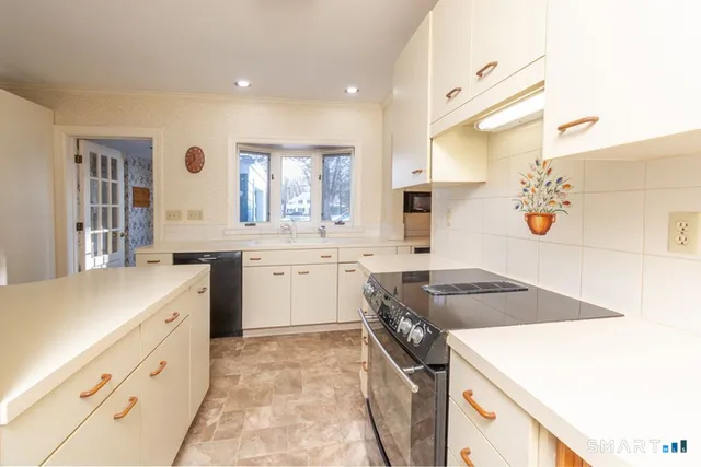 a kitchen that has a sink and a stove in it