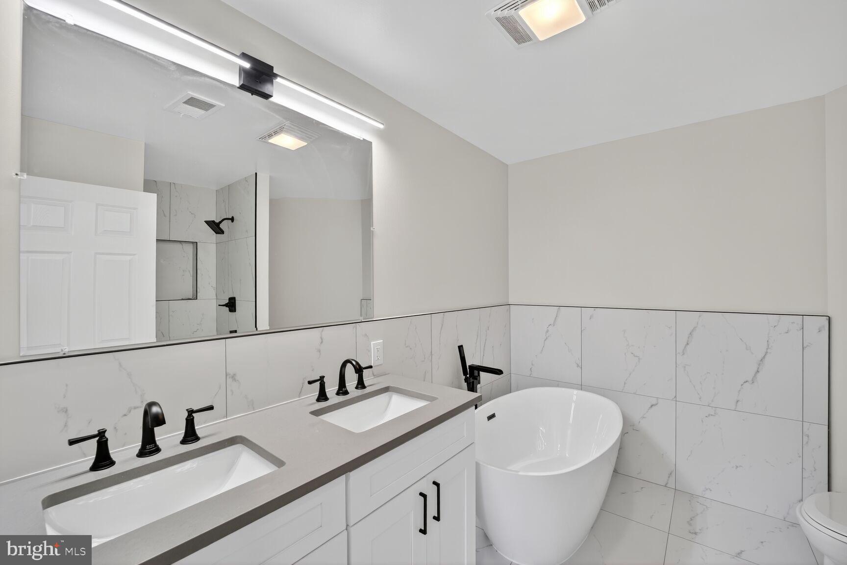 1992 Retta Gilliam Court Southeast Washington, DC 20020 - Photo 14 of 29 a bathroom with a toilet sink and mirror