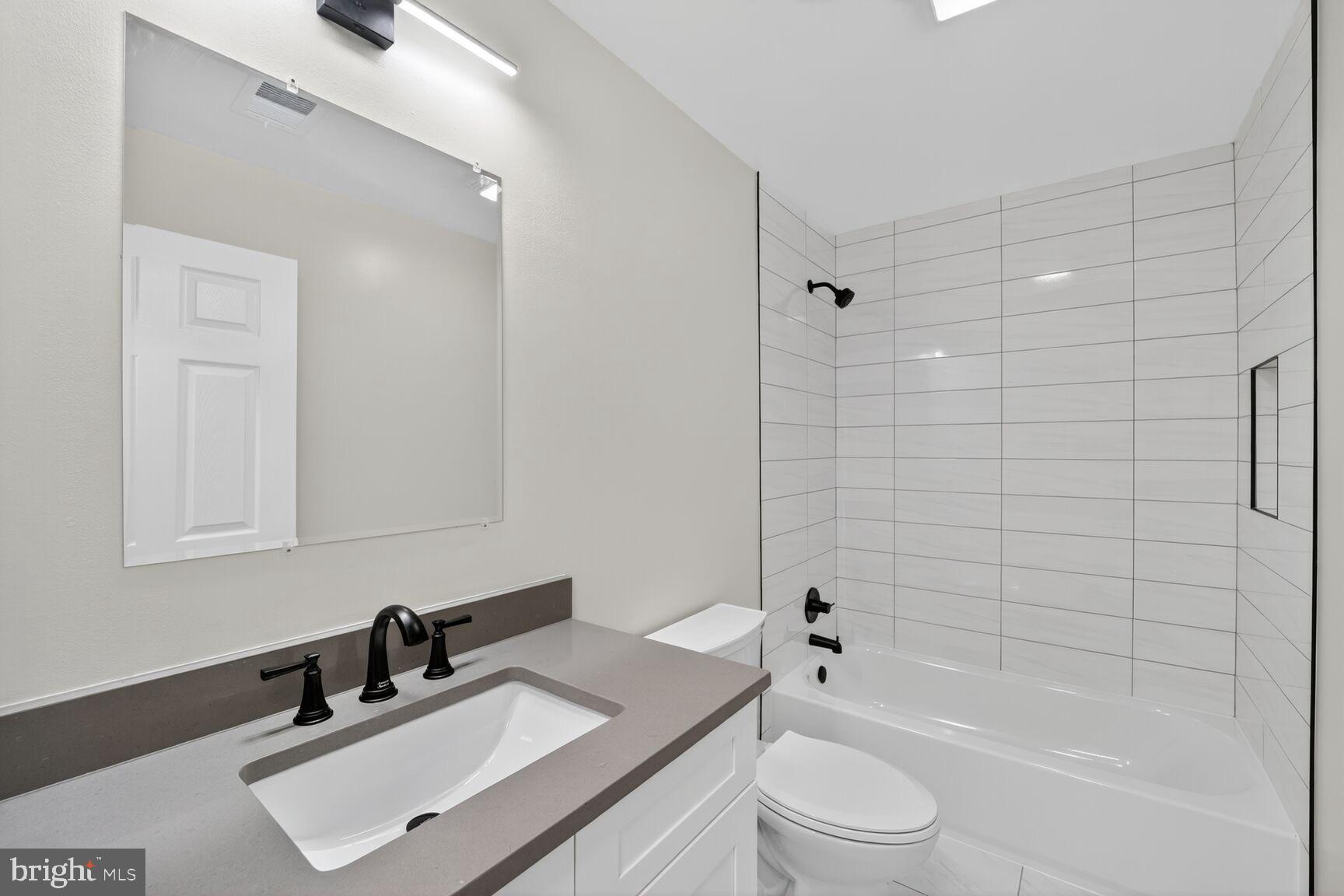 1992 Retta Gilliam Court Southeast Washington, DC 20020 - Photo 20 of 29 a bathroom with a sink a toilet and shower