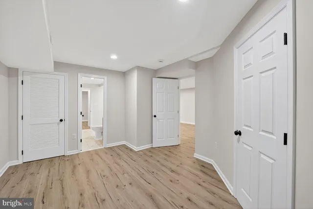a view of a room with wooden floor and white doors