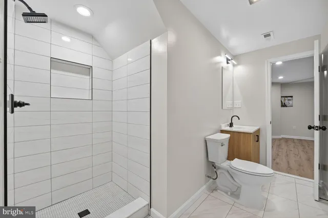 a bathroom with a shower a toilet and a sink