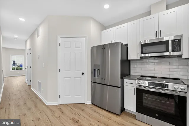 a kitchen with a refrigerator stove and microwave