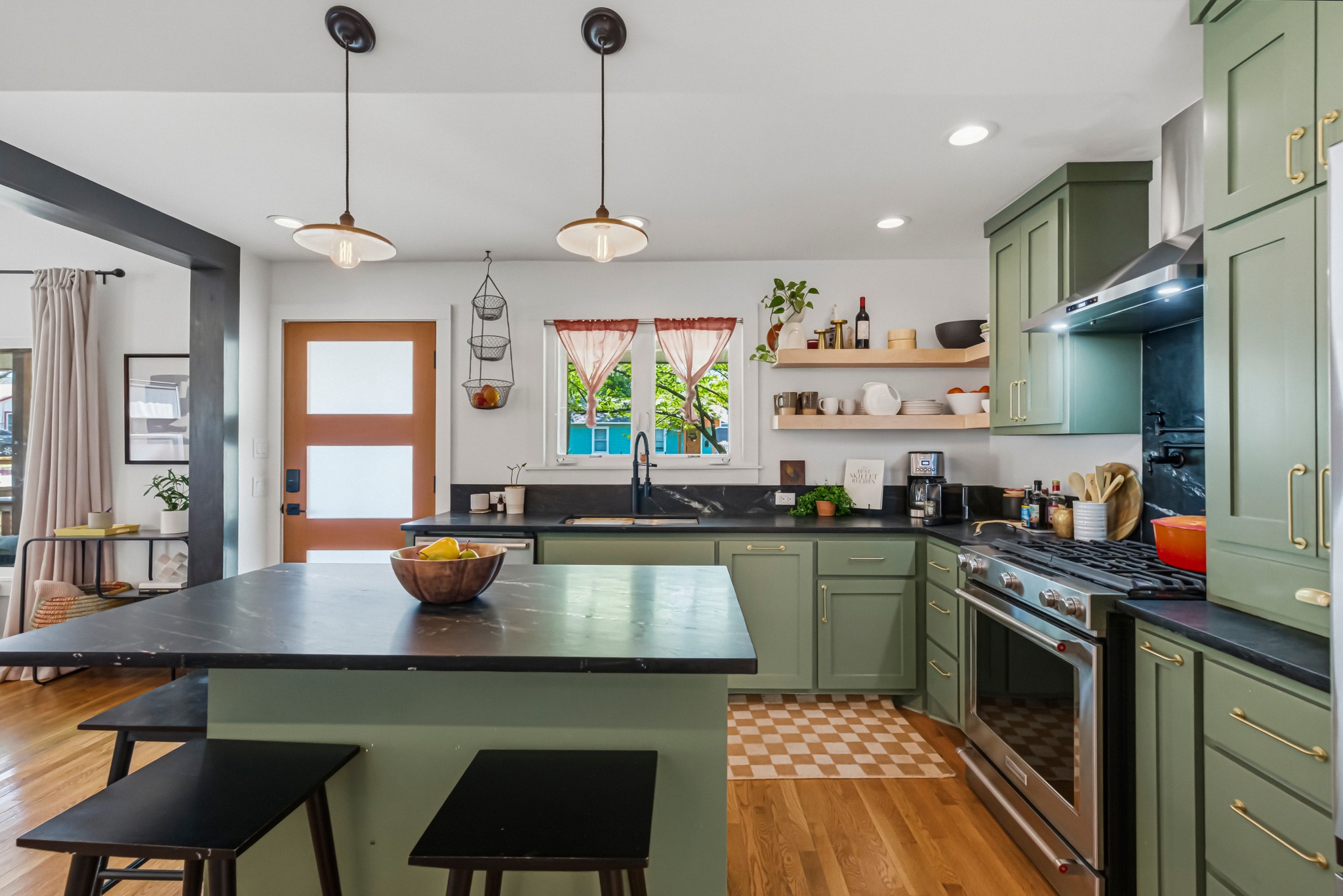 5409 Avenue H Austin, TX 78751 - Photo 11 of 35 a kitchen with stainless steel appliances granite countertop a stove a sink a dining table and chairs with wooden floor