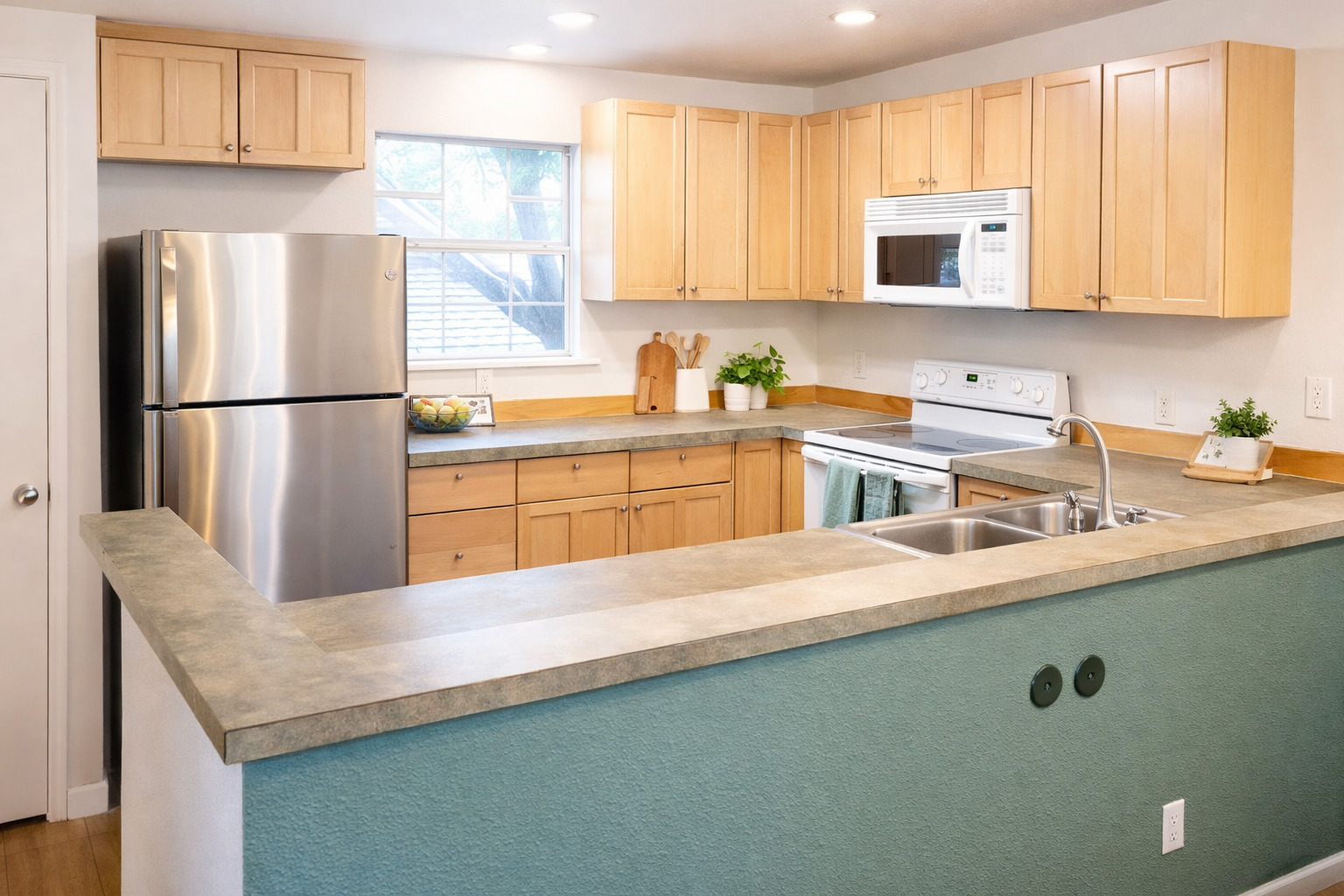 5409 Avenue H Austin, TX 78751 - Photo 25 of 35 a kitchen with stainless steel appliances a refrigerator a sink a stove a microwave a sink and cabinets