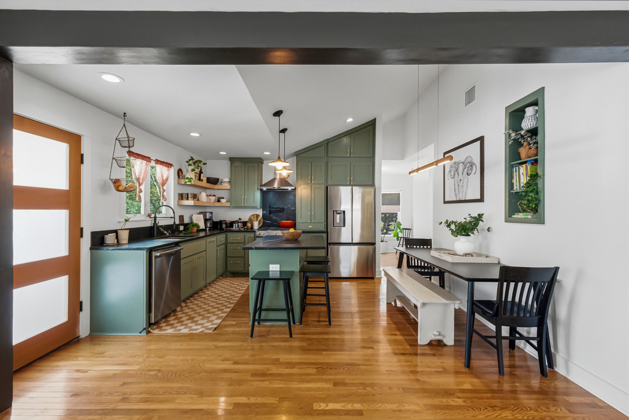5409 Avenue H Austin, TX 78751 - Photo 3 of 35 In the kitchen, custom cabinetry, stainless steel appliances, open shelving, soapstone counters, a center island/breakfast bar, and Schoolhouse Electric pendants.