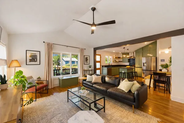 a kitchen with stainless steel appliances a refrigerator a sink a stove a microwave a sink and cabinets
