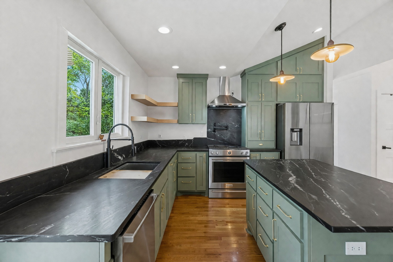 5409 Avenue H Austin, TX 78751 - Photo 10 of 35 a kitchen with stainless steel appliances granite countertop a sink a stove and a refrigerator