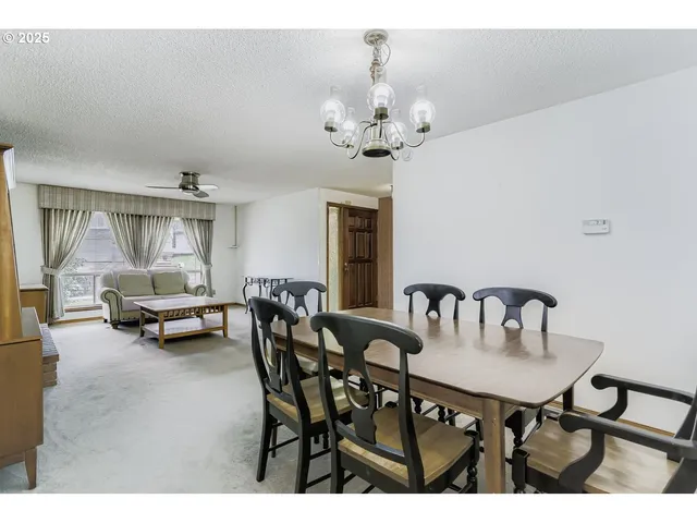 a view of a dining room with furniture and chandelier
