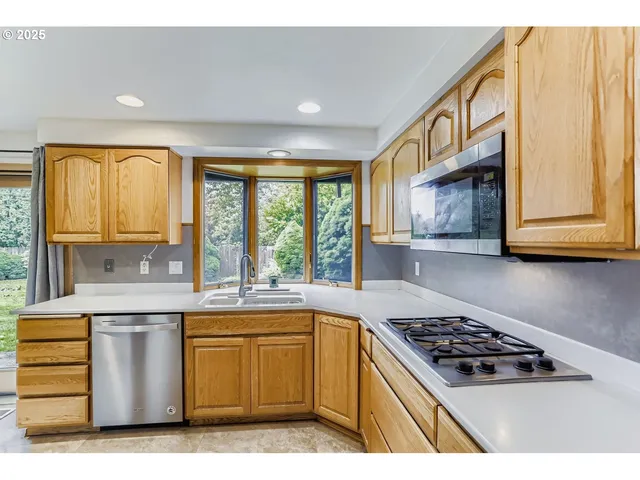 a kitchen with a stove a sink and a microwave