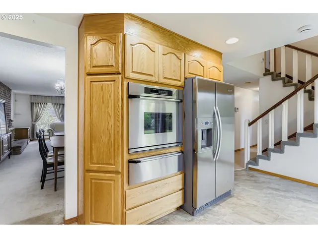 a view of kitchen with furniture and a refrigerator