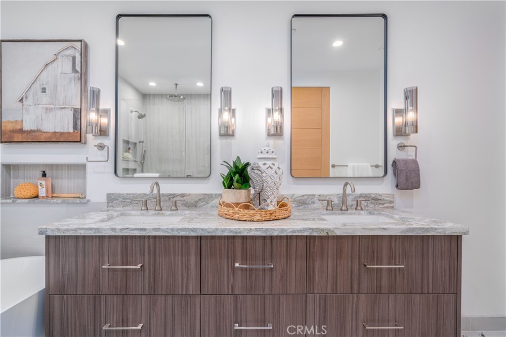 2101 Rockefeller Lane Redondo Beach, CA 90278 - Photo 25 of 45 a bathroom with a granite countertop sink a mirror and shower