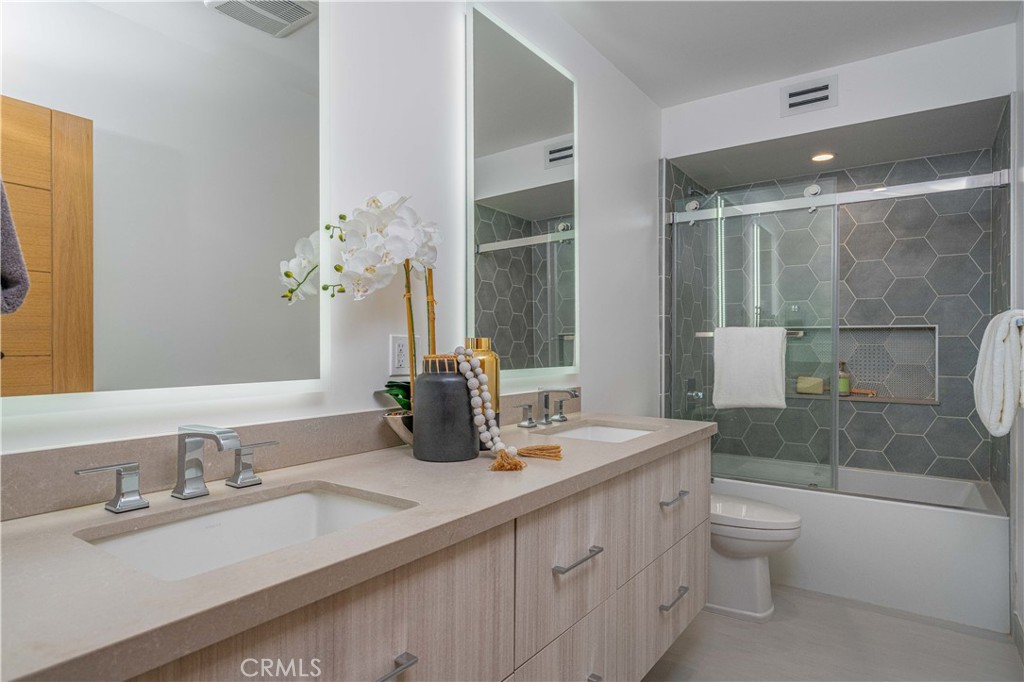 2101 Rockefeller Lane Redondo Beach, CA 90278 - Photo 42 of 45 a bathroom with a granite countertop sink toilet a large mirror and shower