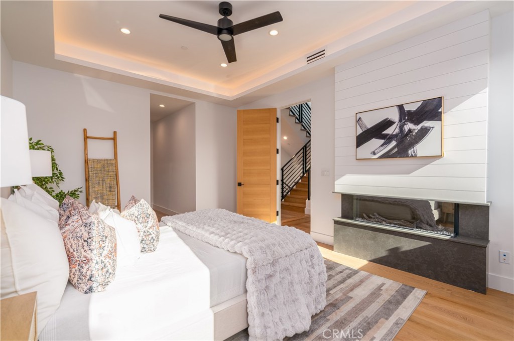 2101 Rockefeller Lane Redondo Beach, CA 90278 - Photo 5 of 45 a bedroom with a bed and a chandelier