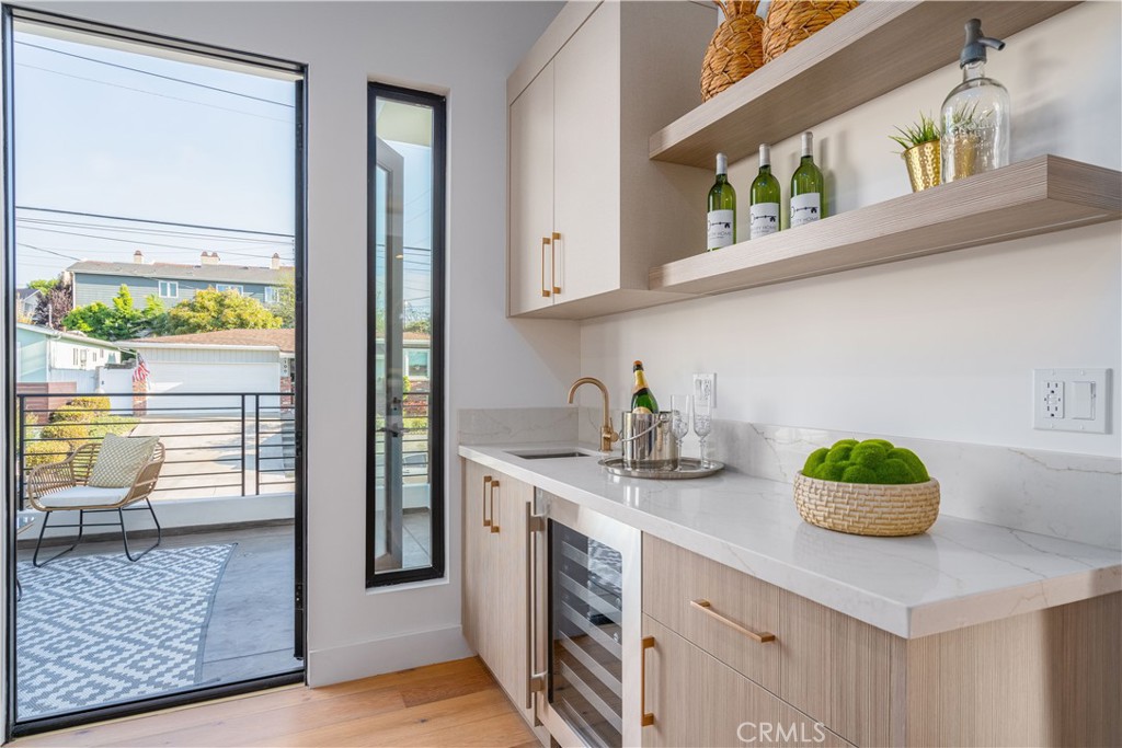 2101 Rockefeller Lane Redondo Beach, CA 90278 - Photo 10 of 45 a kitchen with kitchen island a sink a stove and cabinets