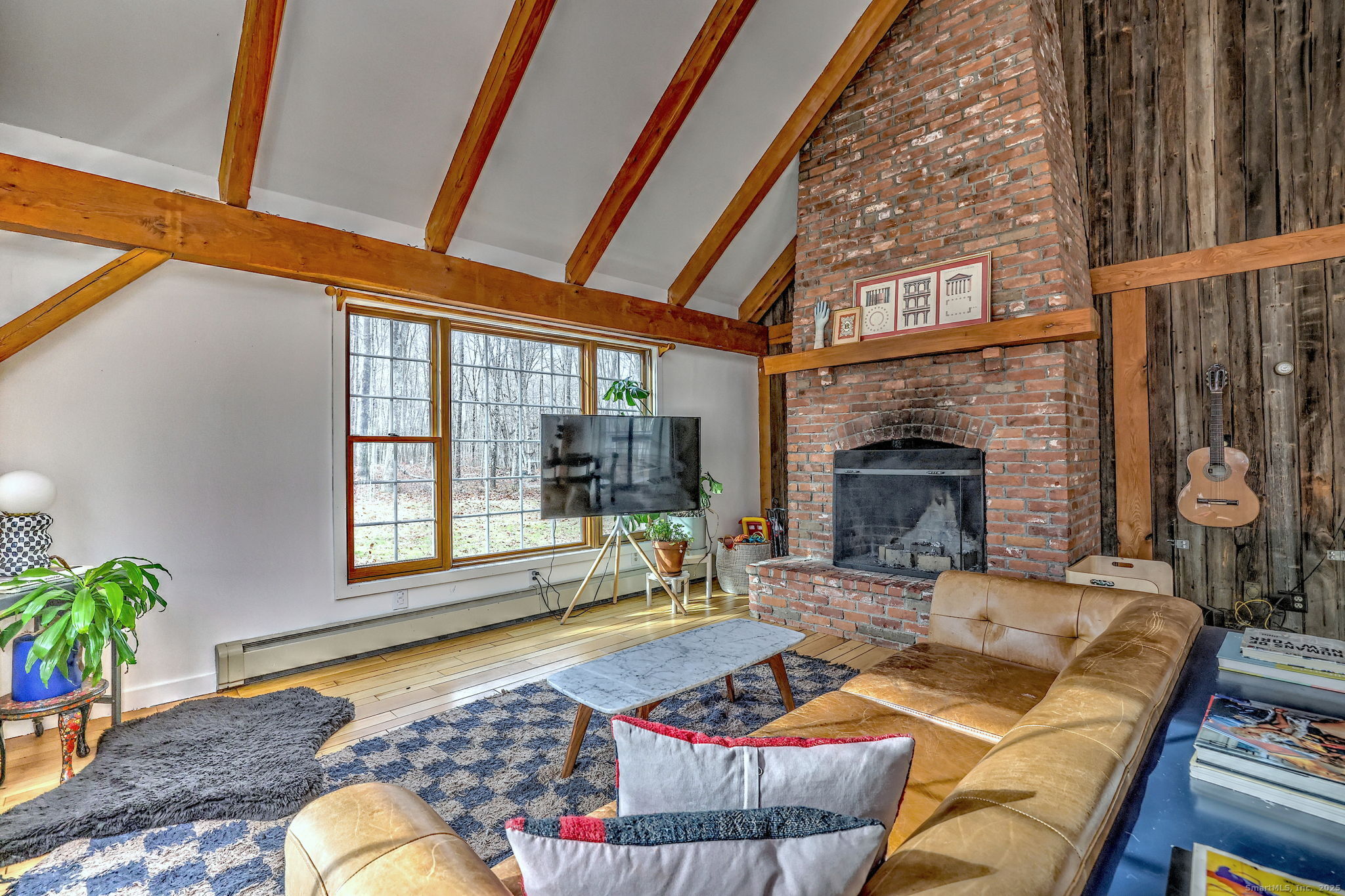 24 Hickory Lane Roxbury, CT 06783 - Photo 18 of 40 a living room with furniture a fireplace and a floor to ceiling window