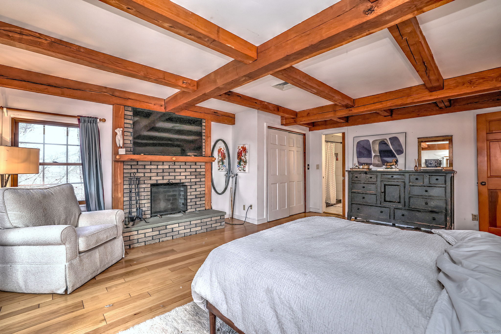 24 Hickory Lane Roxbury, CT 06783 - Photo 24 of 40 a bed room with a bed and a fireplace