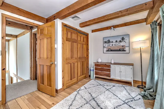 a view of a hallway to rooms and stairs