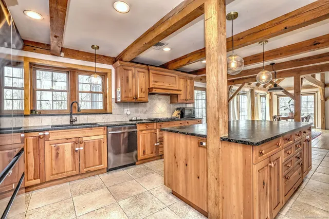 a kitchen with stainless steel appliances granite countertop a stove and a sink
