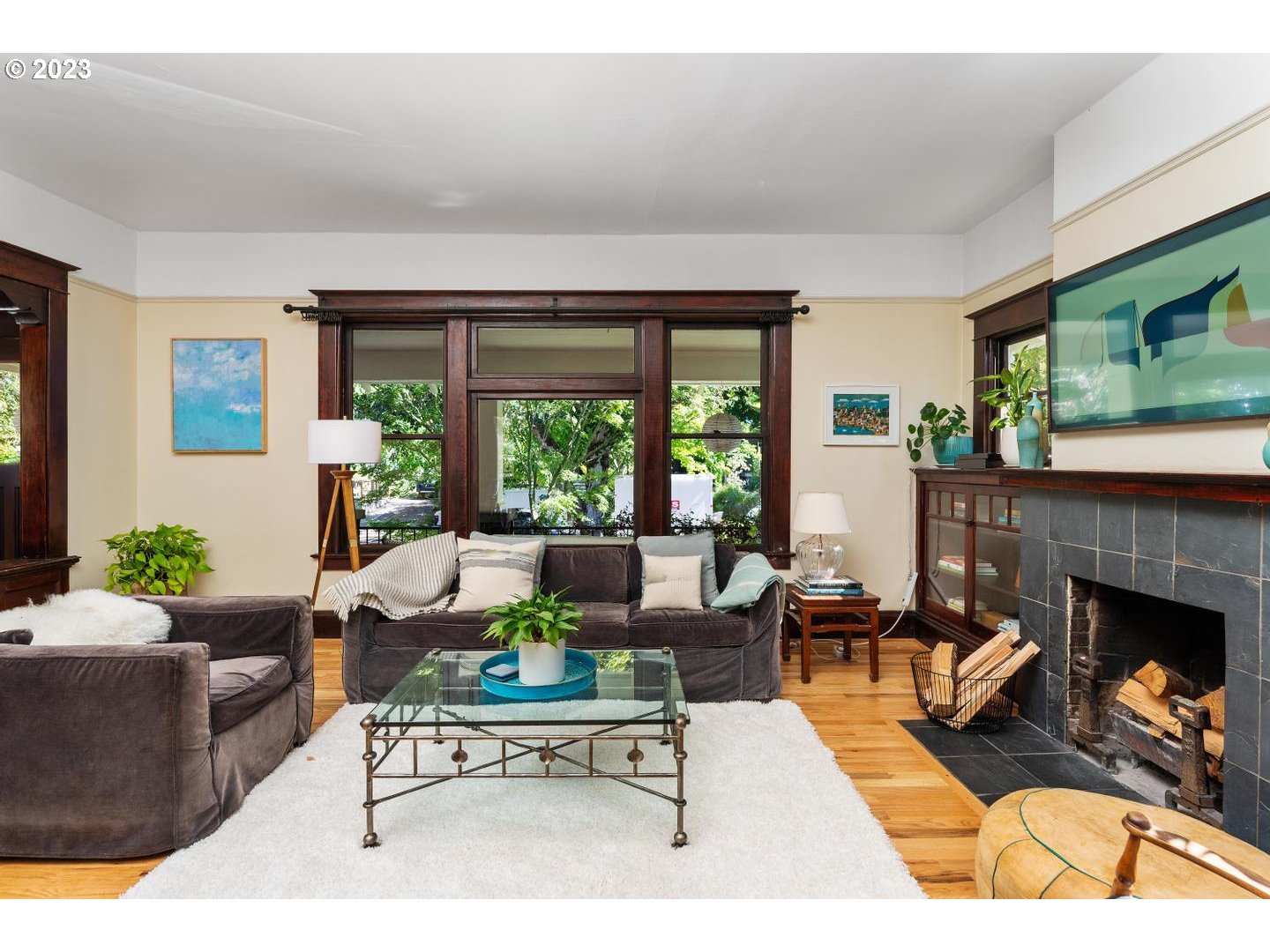 4027 North Colonial Avenue Portland, OR 97227 - Photo 4 of 47 a living room with furniture a large window and a fireplace