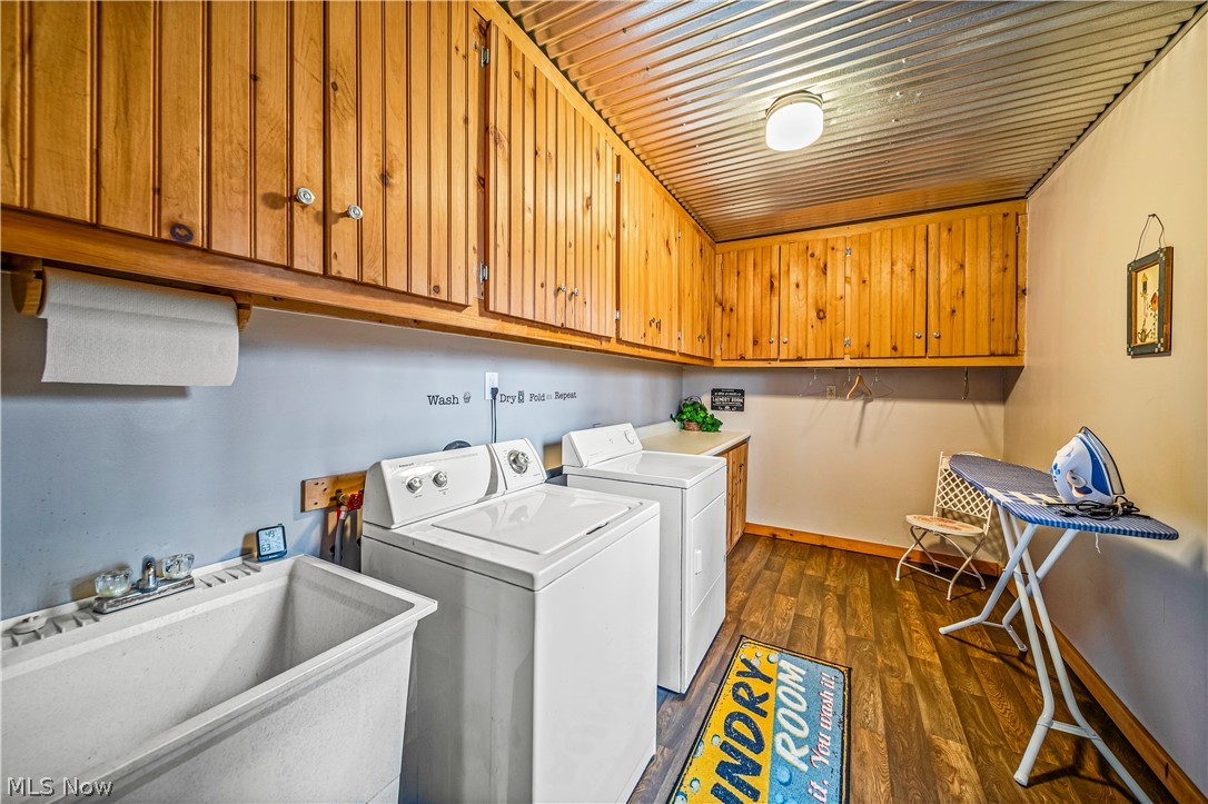 5554 North Ridge Road West Ashtabula, OH 44004 - Photo 18 of 42 Clothes washing area featuring dark wood-type flooring, cabinets, sink, wood ceiling, and washer and dryer