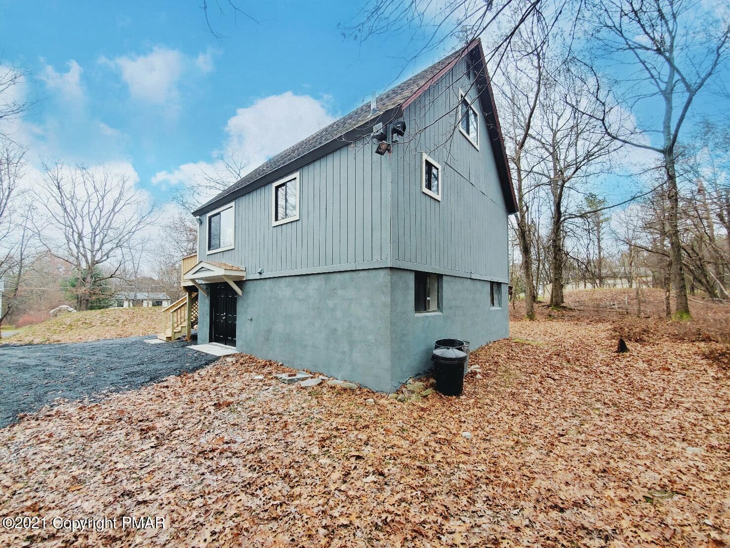 151 Granite Road Long Pond, PA 18334 - Photo 20 of 22 a backyard of a house with large trees