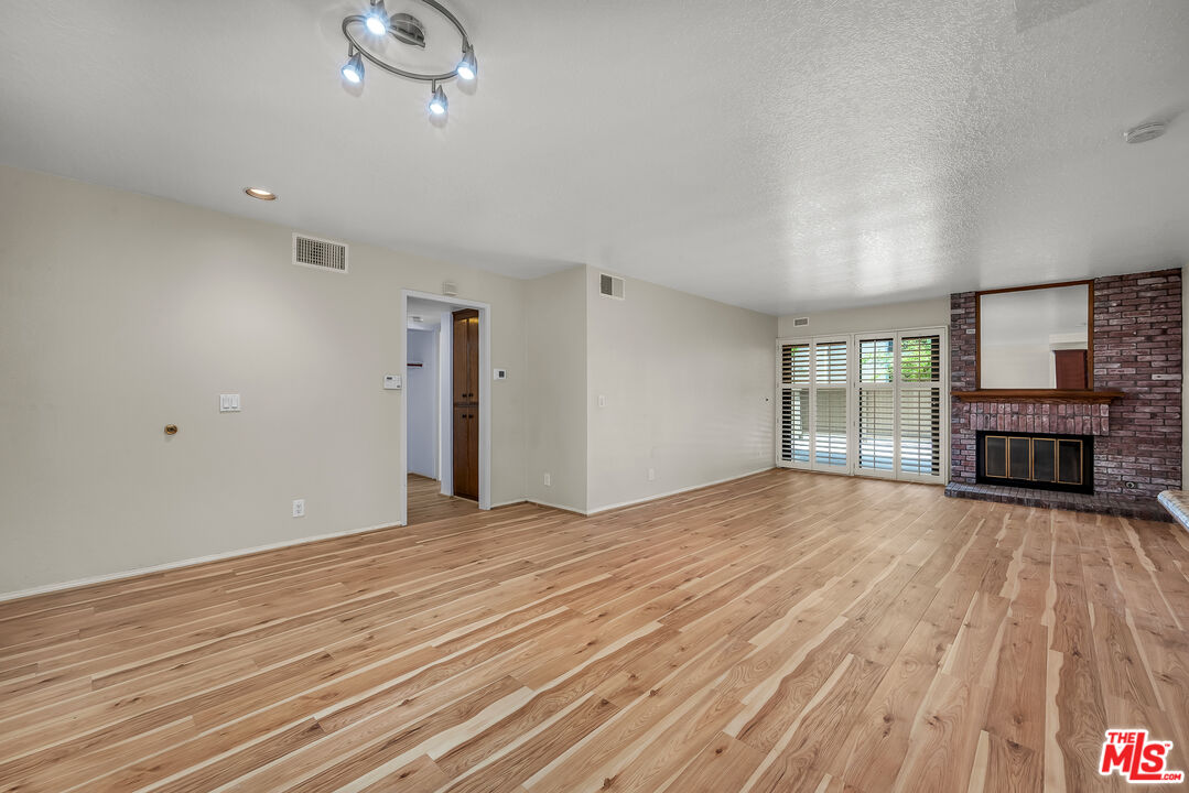 8512 Tuscany Avenue, Unit 207 Playa del Rey, CA 90293 - Photo 12 of 45 a view of an empty room with wooden floor and a window