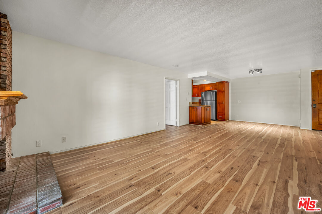 8512 Tuscany Avenue, Unit 207 Playa del Rey, CA 90293 - Photo 13 of 45 a view of empty room with wooden floor