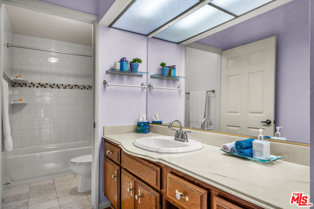 8512 Tuscany Avenue, Unit 207 Playa del Rey, CA 90293 - Photo 20 of 45 a bathroom with a granite countertop sink a toilet and shower