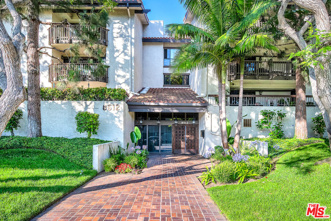 8512 Tuscany Avenue, Unit 207 Playa del Rey, CA 90293 - Photo 2 of 45 a front view of a house with garden