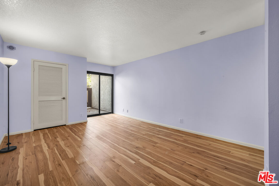 8512 Tuscany Avenue, Unit 207 Playa del Rey, CA 90293 - Photo 23 of 45 an empty room with wooden floor and windows