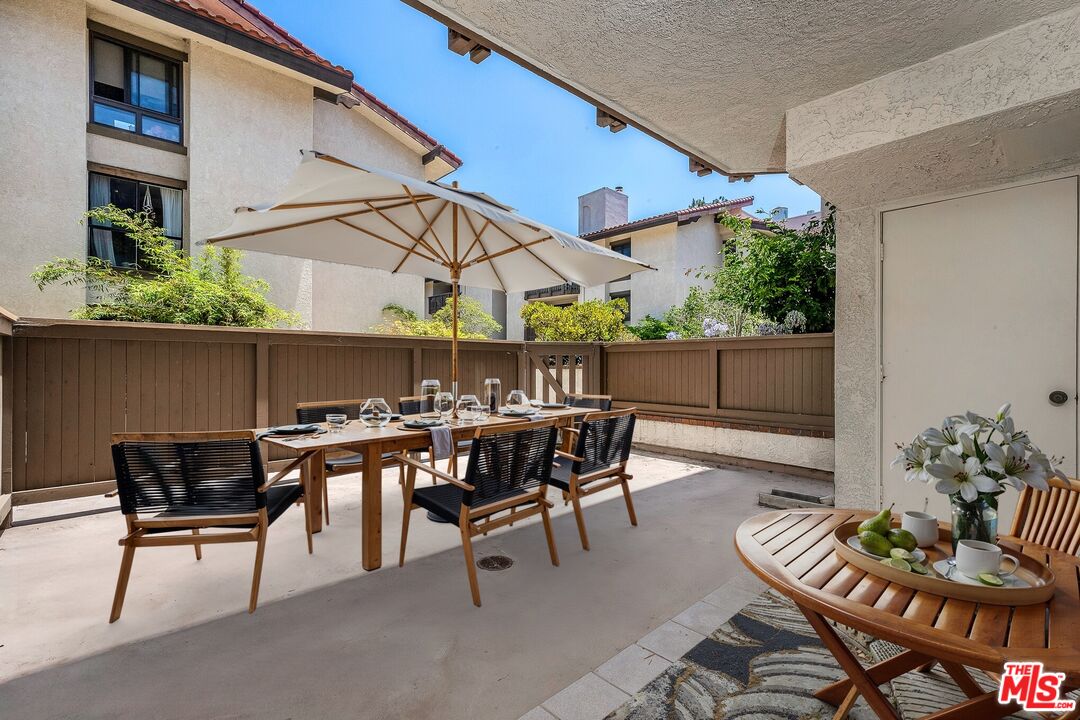 8512 Tuscany Avenue, Unit 207 Playa del Rey, CA 90293 - Photo 32 of 45 a patio with a table and chairs