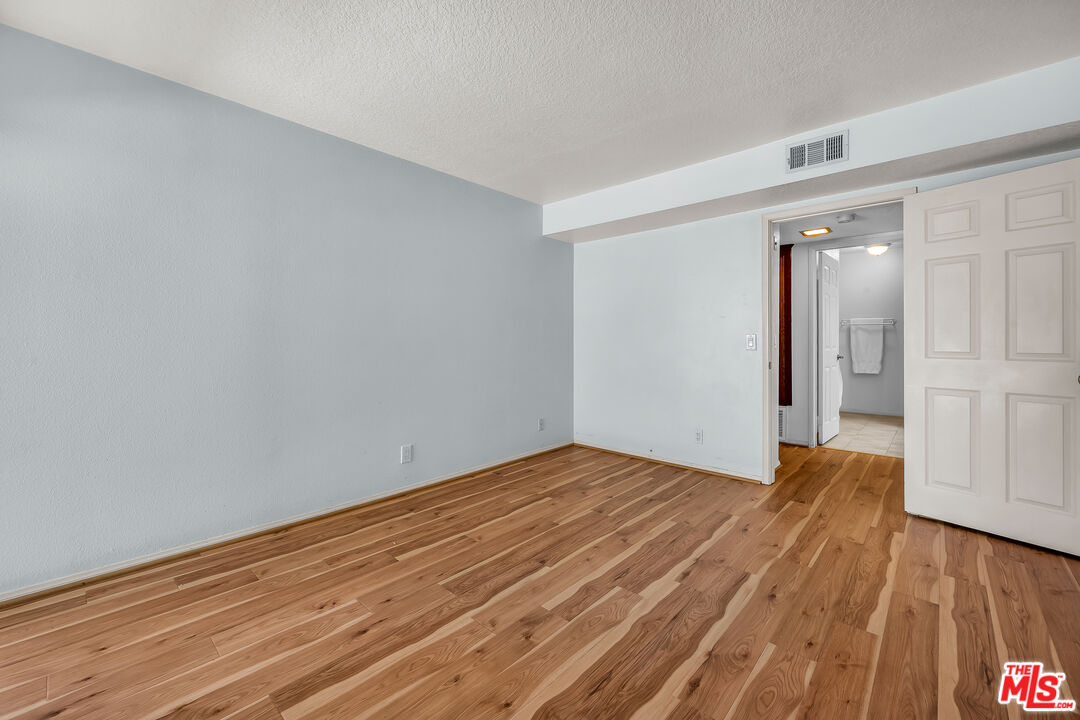 8512 Tuscany Avenue, Unit 207 Playa del Rey, CA 90293 - Photo 35 of 45 a view of empty room with wooden floor
