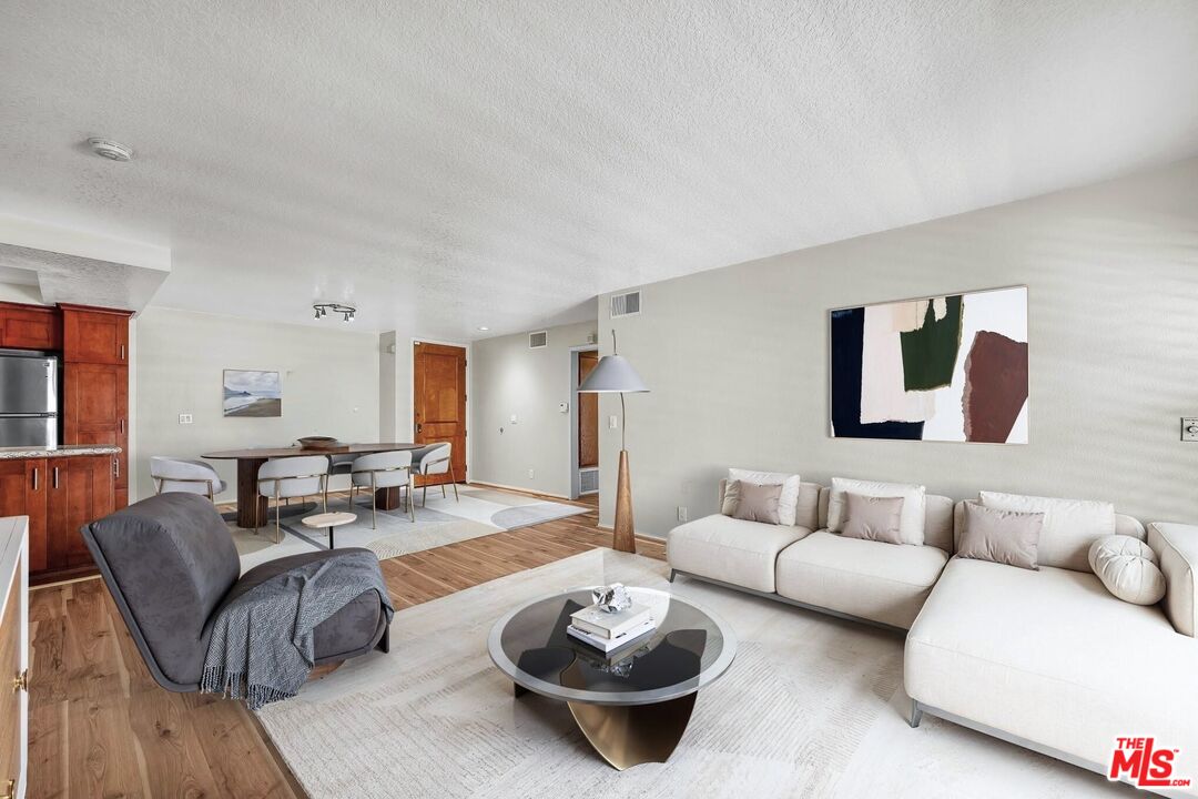 8512 Tuscany Avenue, Unit 207 Playa del Rey, CA 90293 - Photo 4 of 45 a living room with furniture and a table