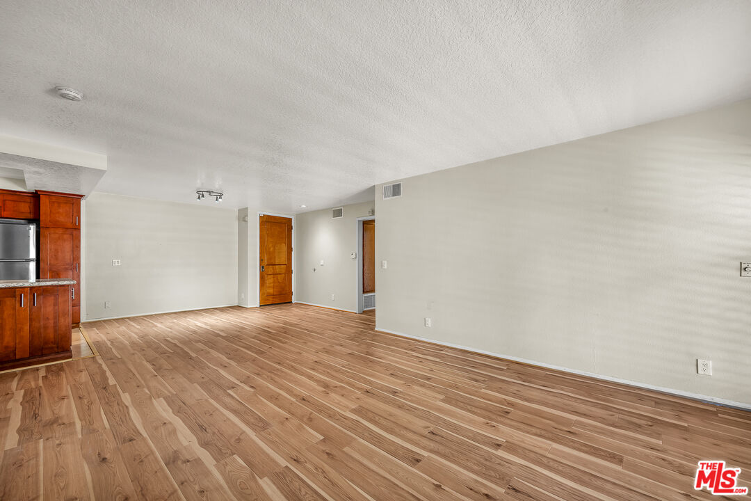 8512 Tuscany Avenue, Unit 207 Playa del Rey, CA 90293 - Photo 5 of 45 a view of empty room with wooden floor
