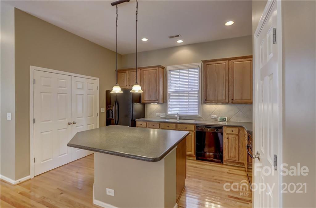 3229 Fifth Baxter Crossing Fort Mill, SC 29708 - Photo 13 of 46 a kitchen with stainless steel appliances granite countertop a sink a stove and a refrigerator