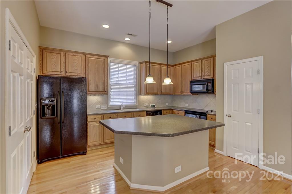 3229 Fifth Baxter Crossing Fort Mill, SC 29708 - Photo 14 of 46 a kitchen with stainless steel appliances granite countertop a sink a refrigerator and a granite counter tops