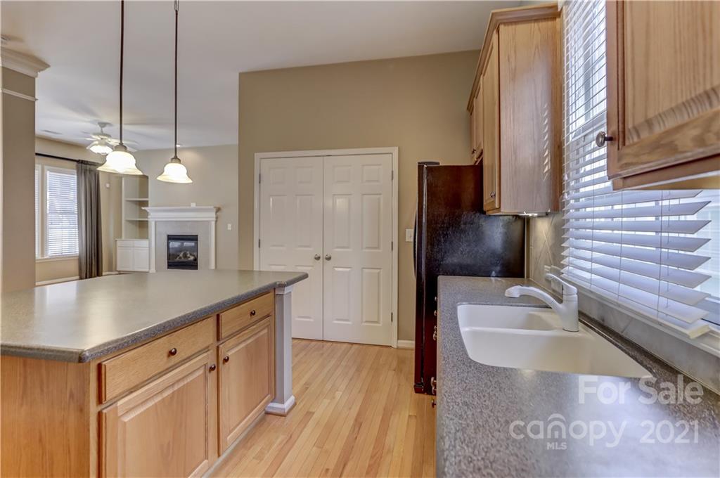 3229 Fifth Baxter Crossing Fort Mill, SC 29708 - Photo 15 of 46 a kitchen with stainless steel appliances granite countertop a sink a refrigerator and a wooden floor