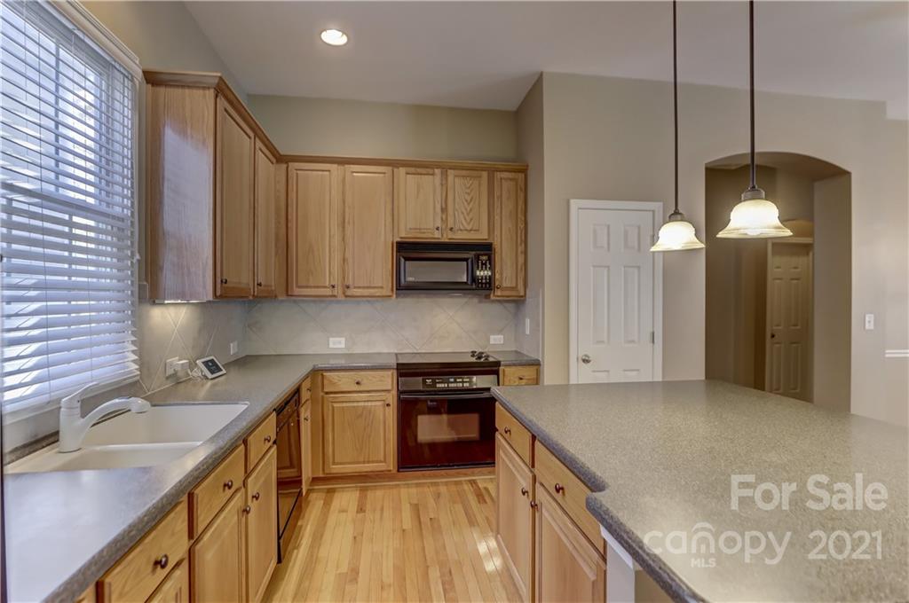 3229 Fifth Baxter Crossing Fort Mill, SC 29708 - Photo 16 of 46 a kitchen with stainless steel appliances granite countertop a sink a stove and a refrigerator